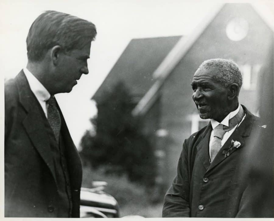George Washington Carver speaks with unknown gentleman, date unknown. 