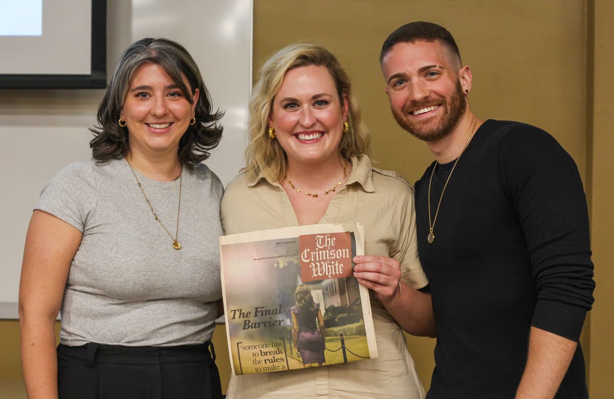  Former Crimson White staff members Abbey Crain, Mazie Bryant and Matt Ford pose with the “Final Barrier” copy.