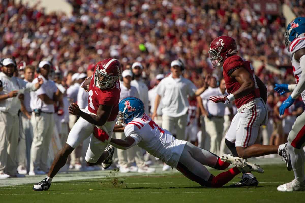 Alabama quarterback Jalen Milroe (#4) attempts to break a tackle from an Ole Miss defender on Sept. 23 at Bryant-Denny Stadium in Tuscaloosa, Ala.