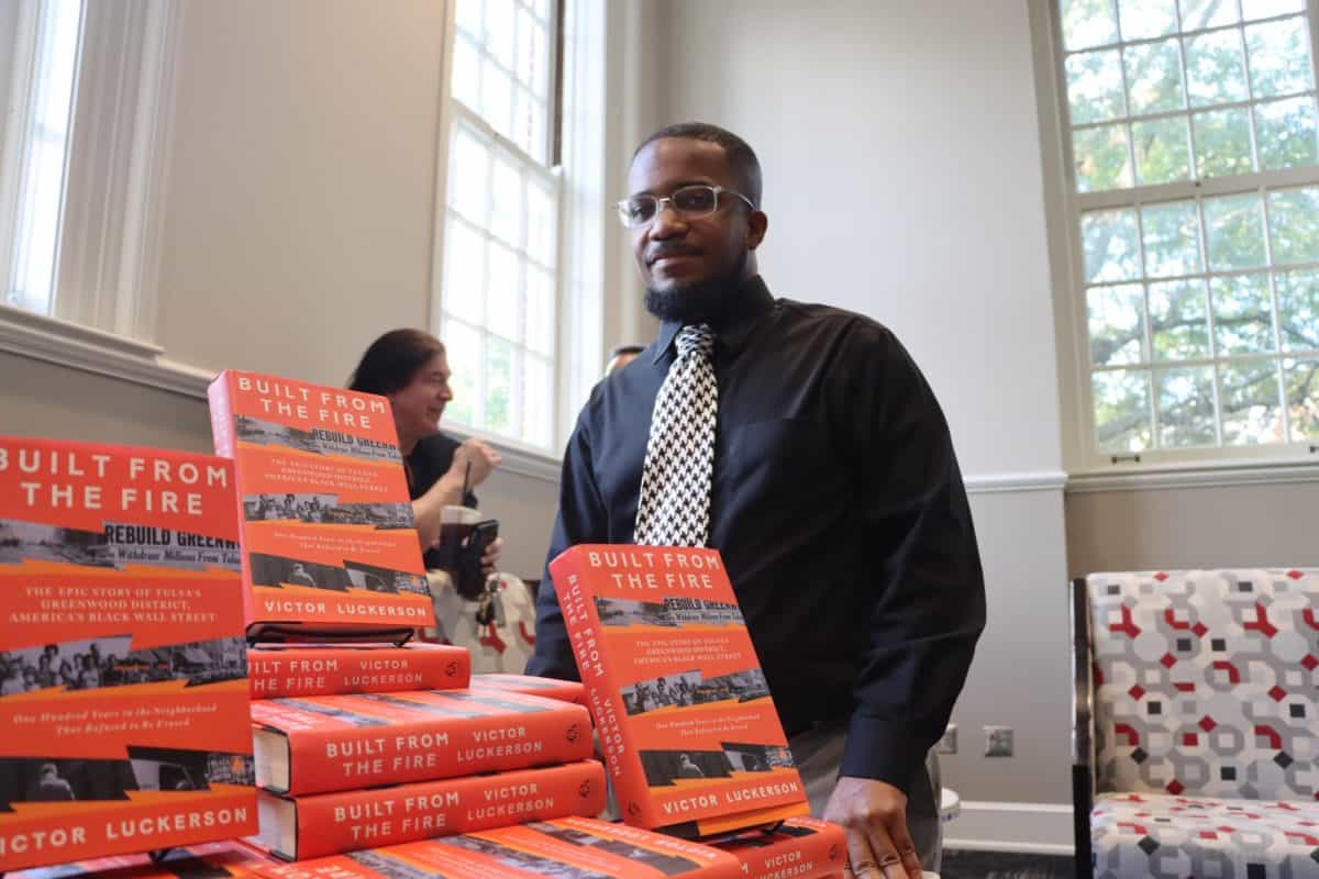 Victor Luckerson posing with his book Built from the Fire at an event held in the Yellowhammer Room of Gorgas Library on Sep. 12.