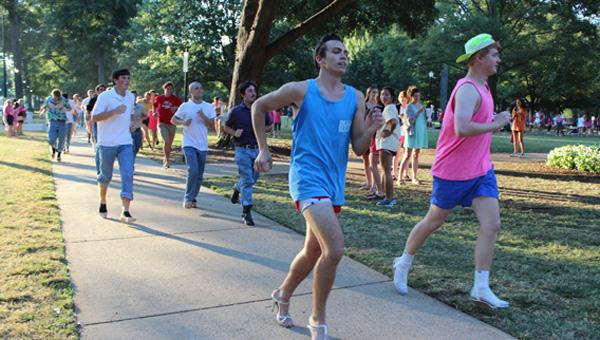 UA men run mile in her shoes to raise domestic abuse awareness