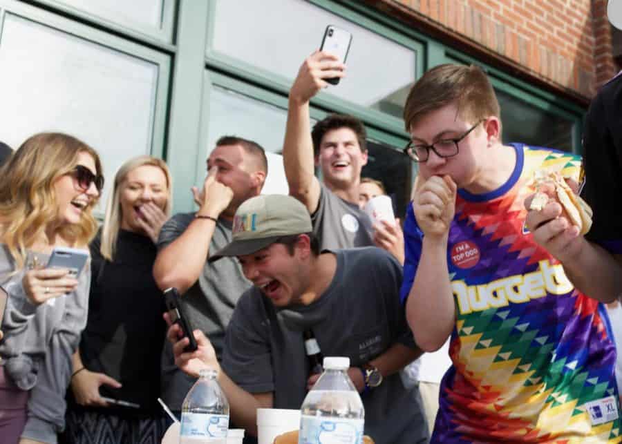 Onlookers cheer for the participants in the T-Town Top Dog hot dog eating contest as part of a Secret Meals For Hungry Children fundraising campaign. CW/ Joe Will Field 