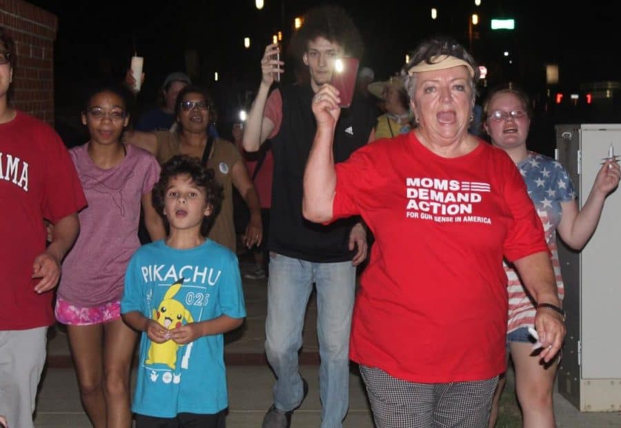 Judy Taylor (pictured) and Sharon Nelson led about 100 Tuscaloosa residents in a candlelight vigil for migrant children Friday evening. 