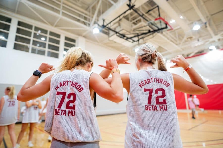 Two teammates with matching jerseys show off their Greek life pride at the student dodgeball competition at the Student Recreation Center.