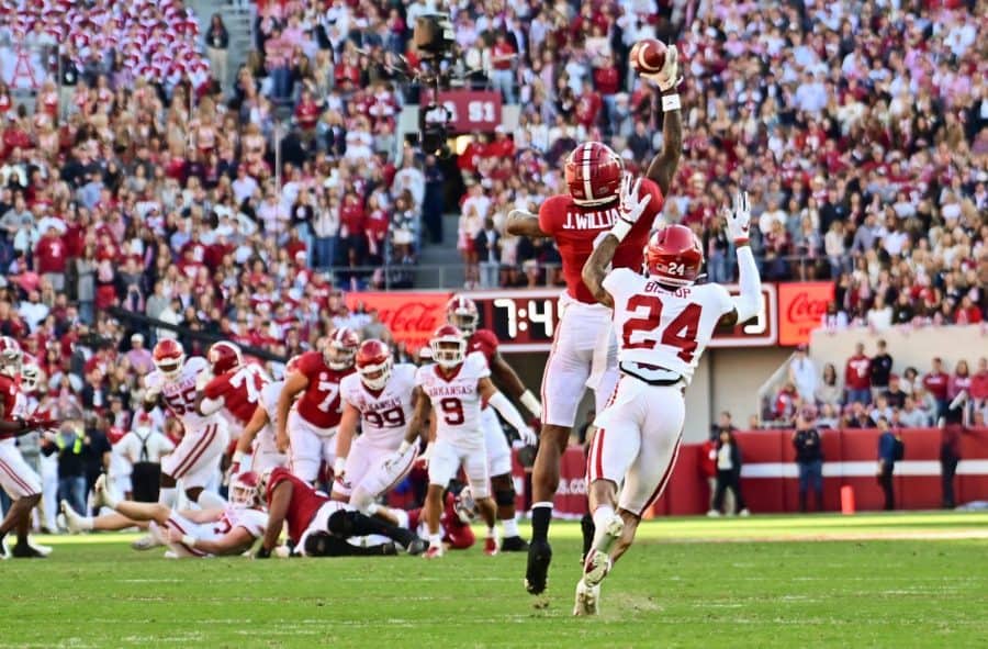 Alabama+wide+receiver+Jameson+Williams+jumps+over+an+Arkansas+defender+to+catch+a+pass+from+Bryce+Young+on+Saturday%2C+Nov.+21.+