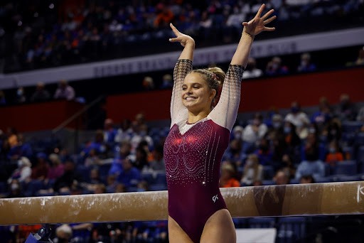 Freshman Lilly Hudson salutes before her balance beam routine against the Florida Gators on Sunday.