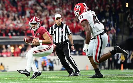 Alabama quarterback Bryce Young is chased down by Georgia linebacker Channing Tindall in the Bulldogs 33-18 CFP National Championship victory.