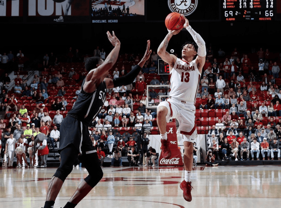 Alabama guard Jahvon Quinerly (13) shoots a step-back jumper over Bulldogs guard Iverson Molinar (1) in the Crimson Tide’s 80-75 win Wednesday night at Coleman Coliseum.