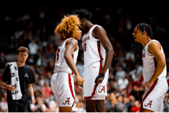 Charles Bediako (10) and Jaden Shackelford (5) celebrate with JD Davison (3) after a bucket in Alabama’s 68-67 win over the Arkansas Razorbacks on Feb. 12.