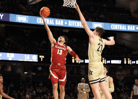 Alabama guard Jahvon Quinerly (13) drives in for the layup on Vanderbilt’s Liam Robbins (21) in the Crimson Tide’s 74-72 victory at Memorial Gymnasium in Nashville, Tennessee, on Feb. 22.