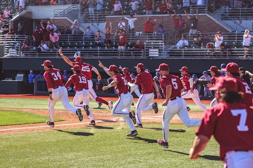 The Alabama baseball team storms the field after defeating the No. 9 Florida Gators 8-7 on March 20, at Sewell-Thomas Stadium. 