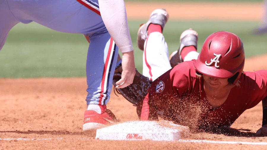 Alabama shortstop Jim Jarvis (10) slides into first base on a pickoff attempt in the Crimson Tide’s 7-4 victory over the No. 9 Ole Miss Rebels on April 10 at Swayze Field in Oxford, Mississippi.
