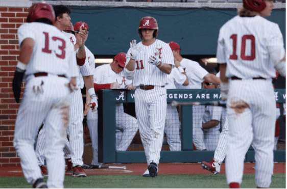 William Hamiter (11) cheers on his teammates after a three-run seventh inning in Alabama’s 10-9 victory over the Texas A&M Aggies on April 2 at Sewell-Thomas Stadium in Tuscaloosa, Alabama. 