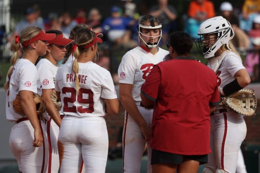 Alabama pitcher Montana Fouts (14) engages in a mound visit with pitching coach Stephanie VanBrakle Prothro in the Crimson Tides 3-0 loss to the Missouri Tigers in the SEC Tournament Quarterfinals at Katie Seashole Pressly Stadium in Gainesville, Florida.