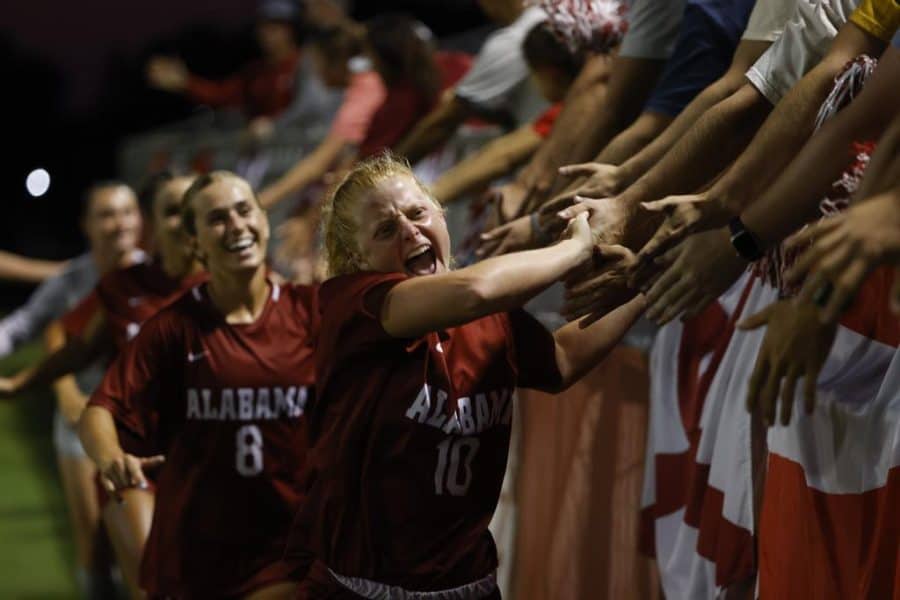 Alabama forward Riley Mattingly Parker (10) and midfielder Felicia Knox (8) celebrate with fans following the Crimson Tides 3-1 exhibition victory over the Vanderbilt Commodores on August 13 at the Alabama Soccer Stadium in Tuscaloosa, Alabama.