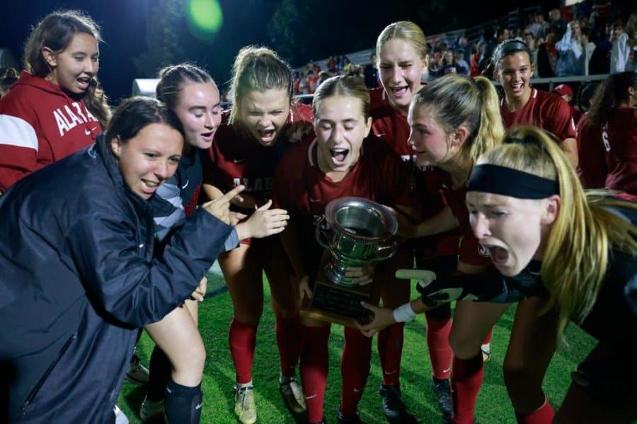 The Alabama soccer team celebrates with the Iron Bowl trophy in the Crimson Tides 1-0 win over the Auburn Tigers on Oct. 27 at the Auburn Soccer Complex in Auburn, Ala.