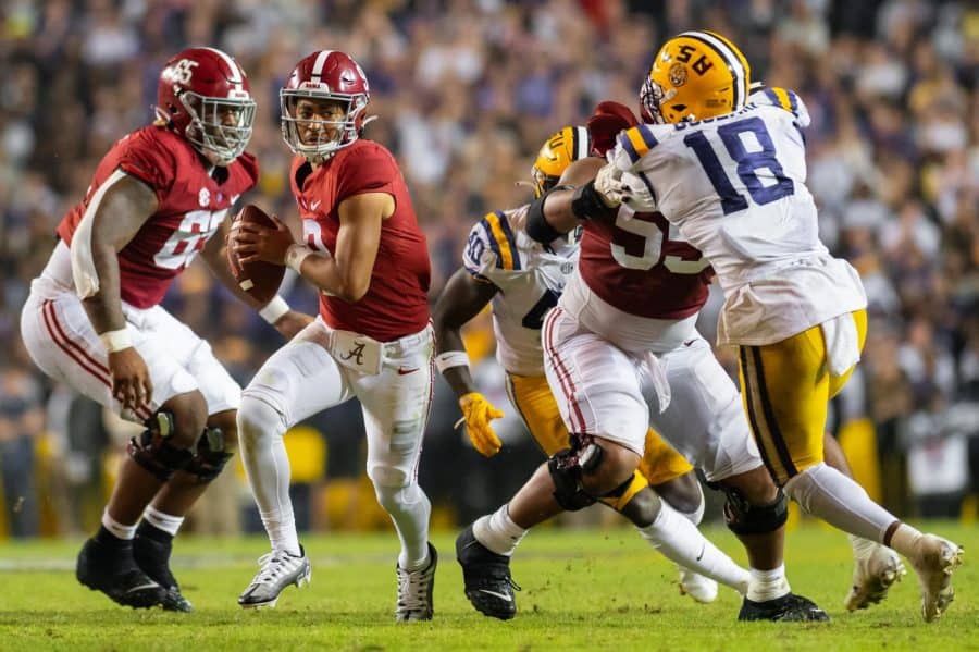 Alabama quarterback Bryce Young (9) looks to escape pressure in the Crimson Tide’s 32-31 overtime loss to the No. 10 LSU Tigers on Nov. 5 at Tiger Stadium in Baton Rouge, La.
