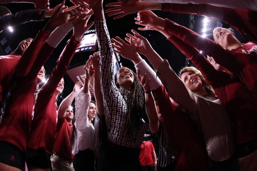 Head coach Rashinda Reed and the Alabama volleyball team smiles during a huddle in the Crimson Tides win over the Texas A&M Aggies on Nov. 2 at Reed Arena in College Station, Texas.