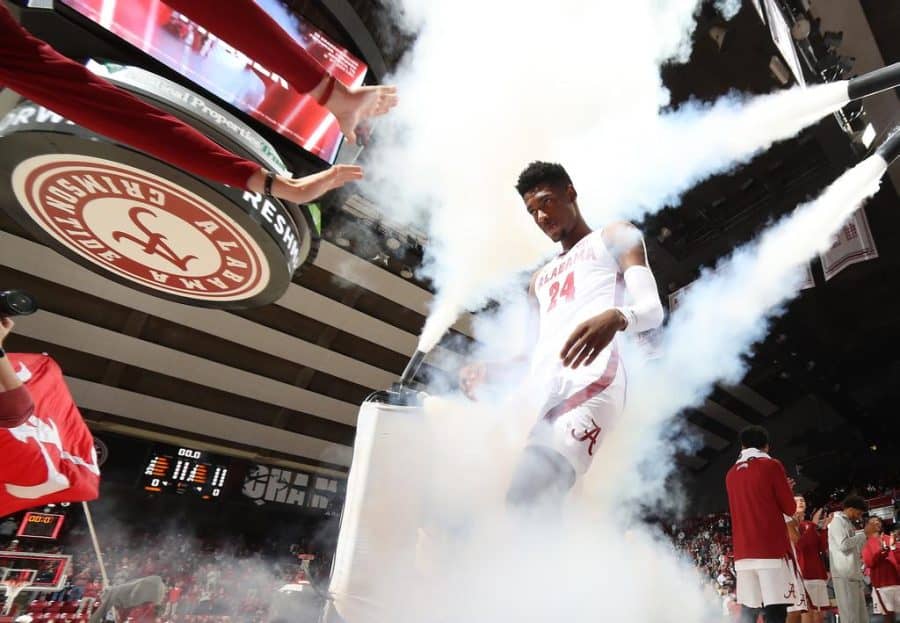 Alabama forward Brandon Miller (24) runs through the smoke during introductions against Jacksonville State on Nov. 18 at Coleman Coliseum in Tuscaloosa, Ala.