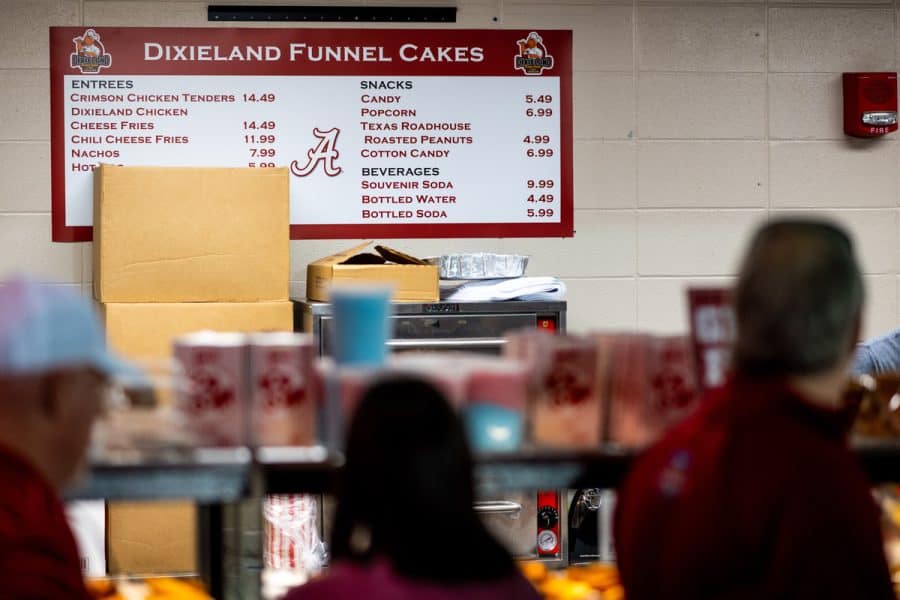 Fans wait in line to pay the raised Coleman Coliseum concession prices of the 2022-2023 season.