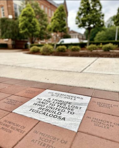A tile at the front and center of the Crimson Promenade remembers the lives lost in the 2011 tornadoes. / UA Instagram