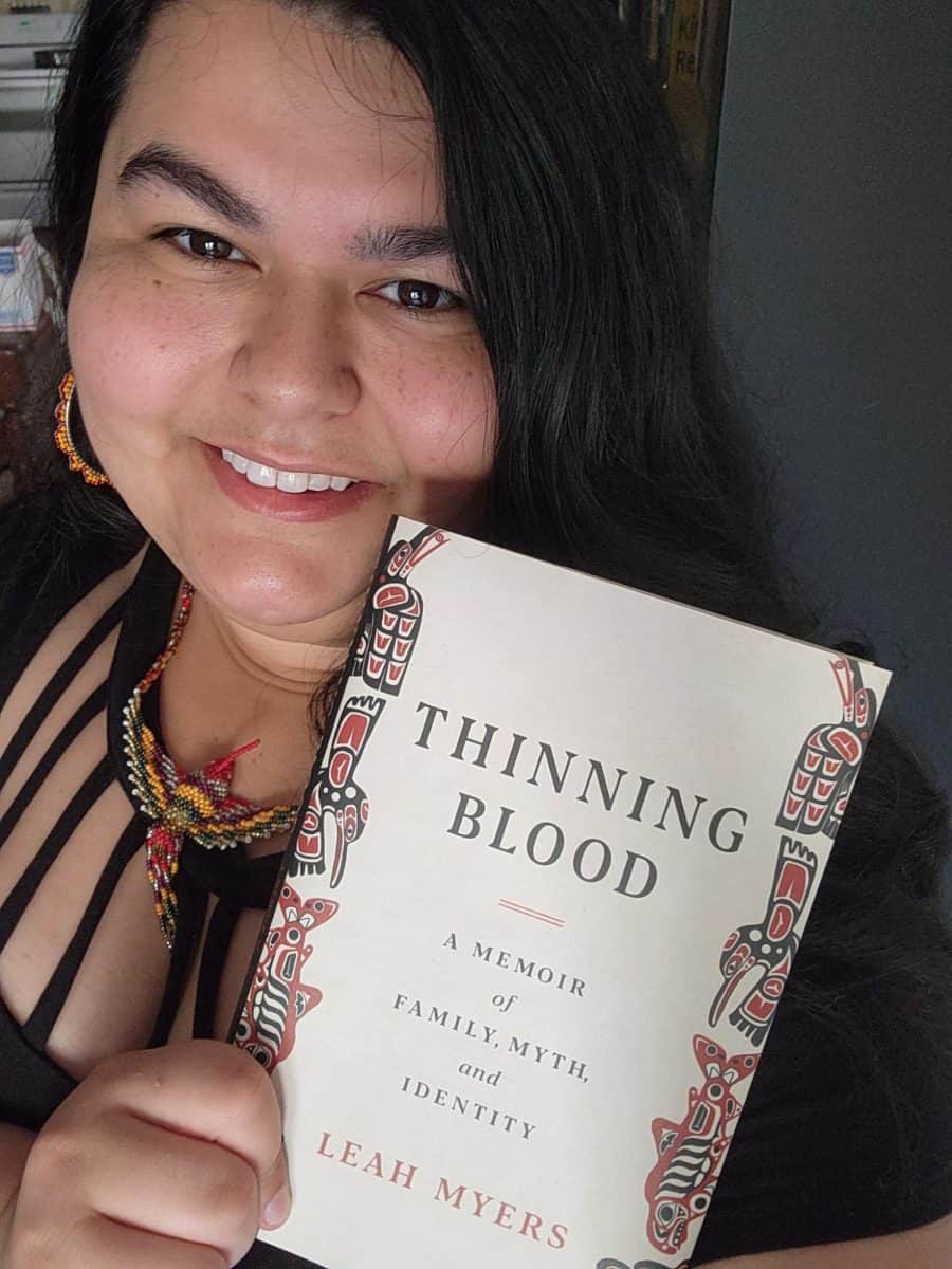 UA staff member, Leah Myers, holding her debut memoir, “Thinning Blood: A Memoir of Family, Myth, and Identity.”