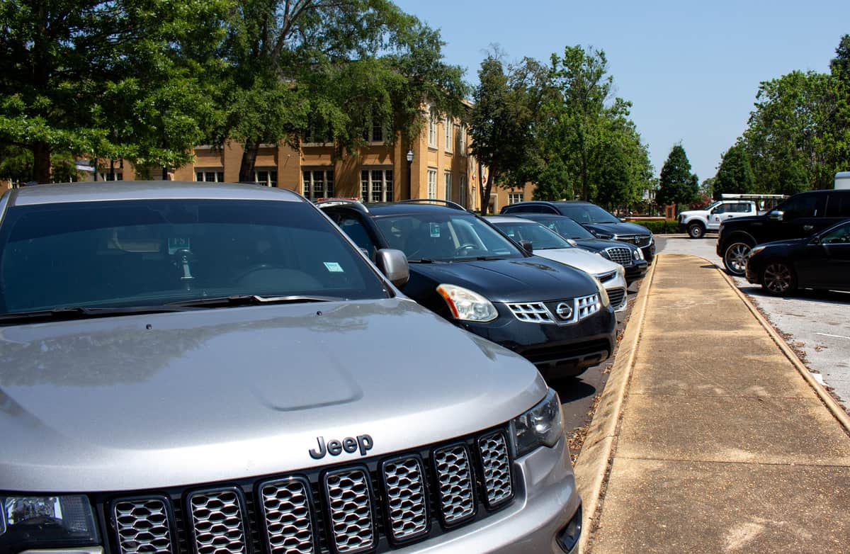 Cars parked by Presidents Hall located at Woods Quad