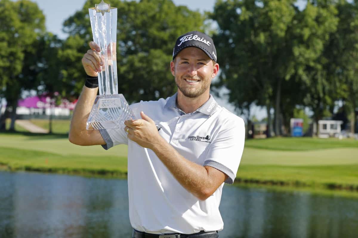 Lee Hodges holds up the trophy after winning the 3M Open golf tournament on July 30 at the Tournament Players Club in Blaine, Minn.