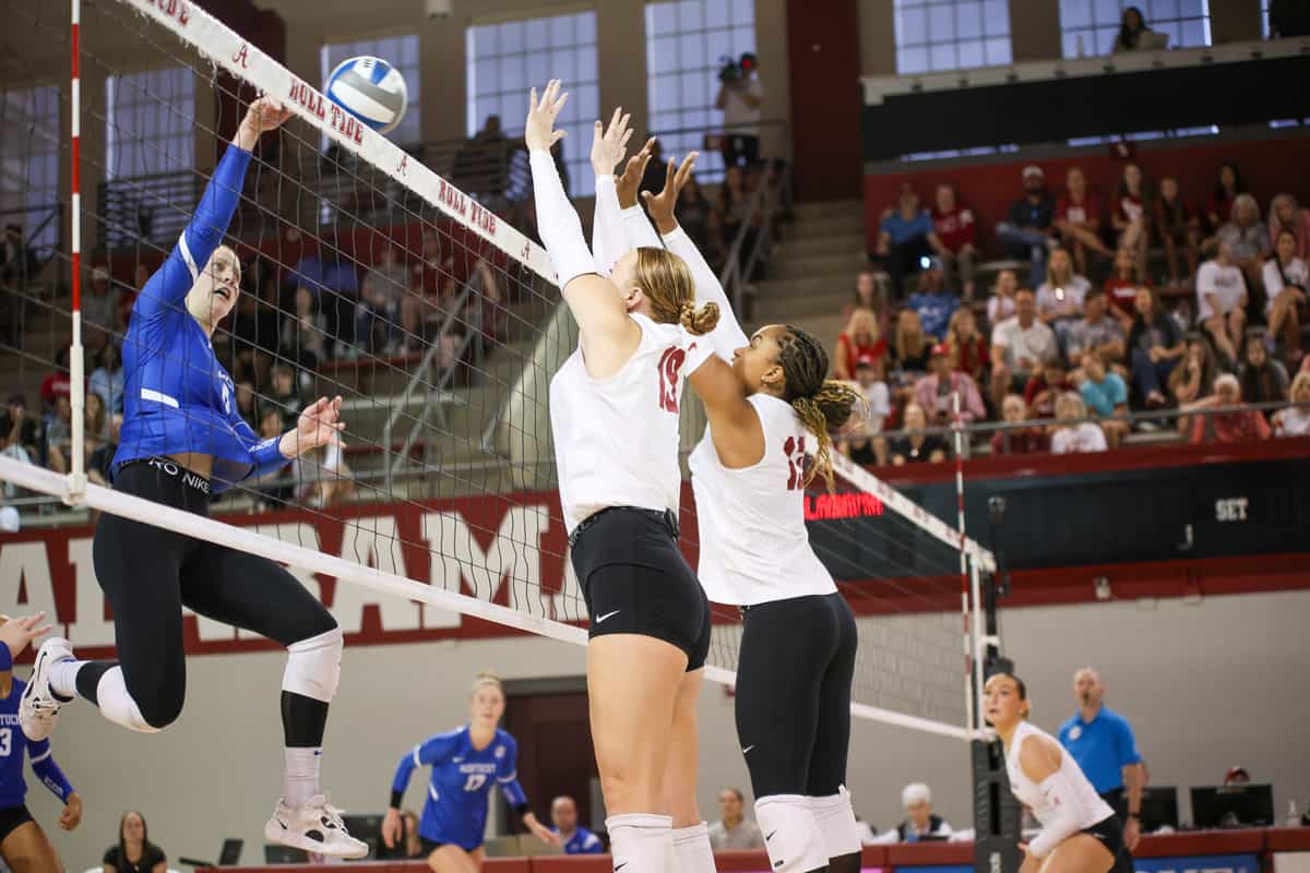 Alabama volleyball players Kendyl Reaugh (#19) and Alyiah Wells (#13) attempt to block the ball against Kentucky on Oct. 1 in Tuscaloosa, Ala.