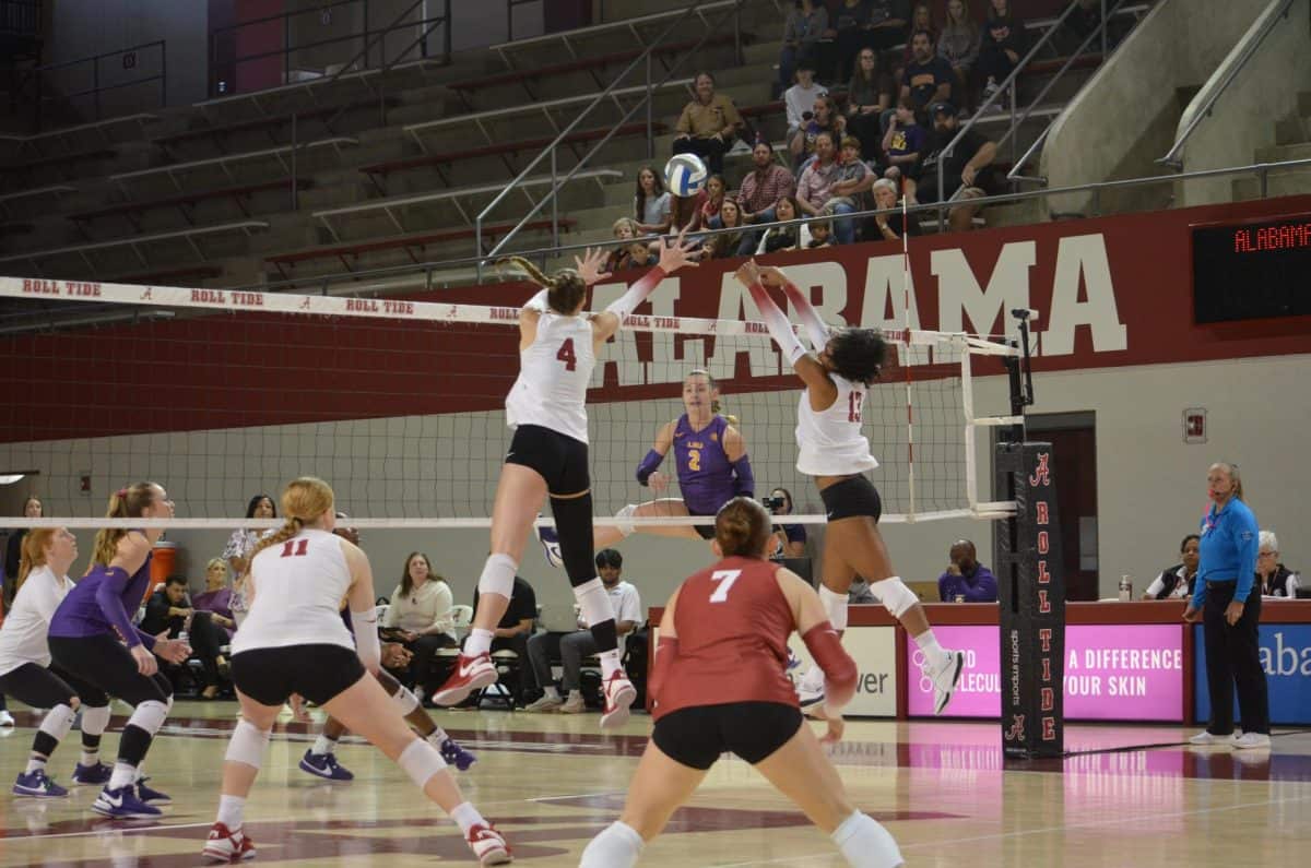 Alabama volleyball players Jordyn Towers (#4) and Alyiah Wells (#13) attempting to block the ball against LSU on Oct. 22 in Tuscaloosa, Ala.