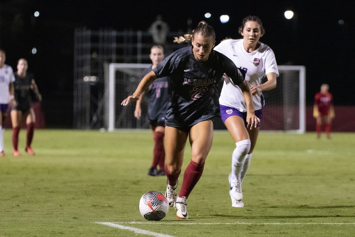  Alabama forward Itala Gemelli (#29) runs with the ball while being chased by a defender.