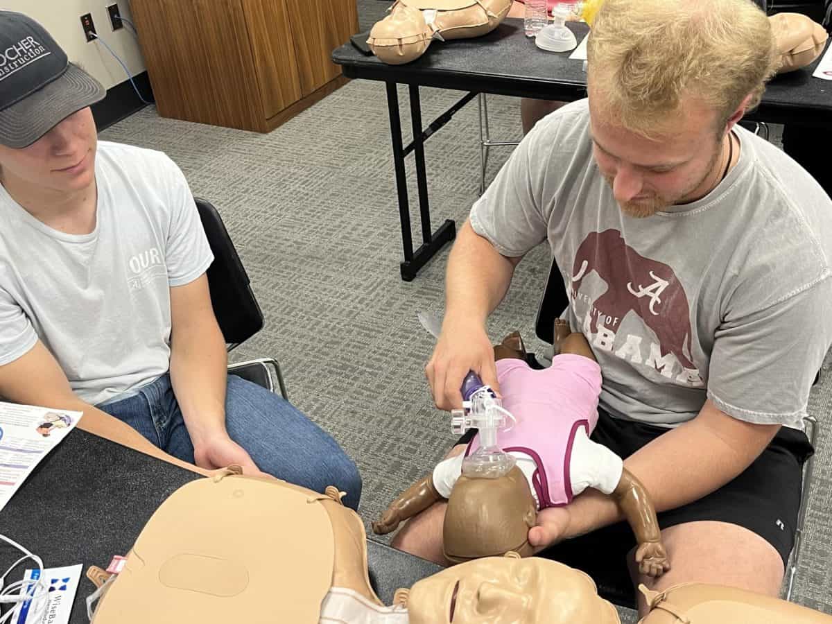 Students particpate in CPR training.