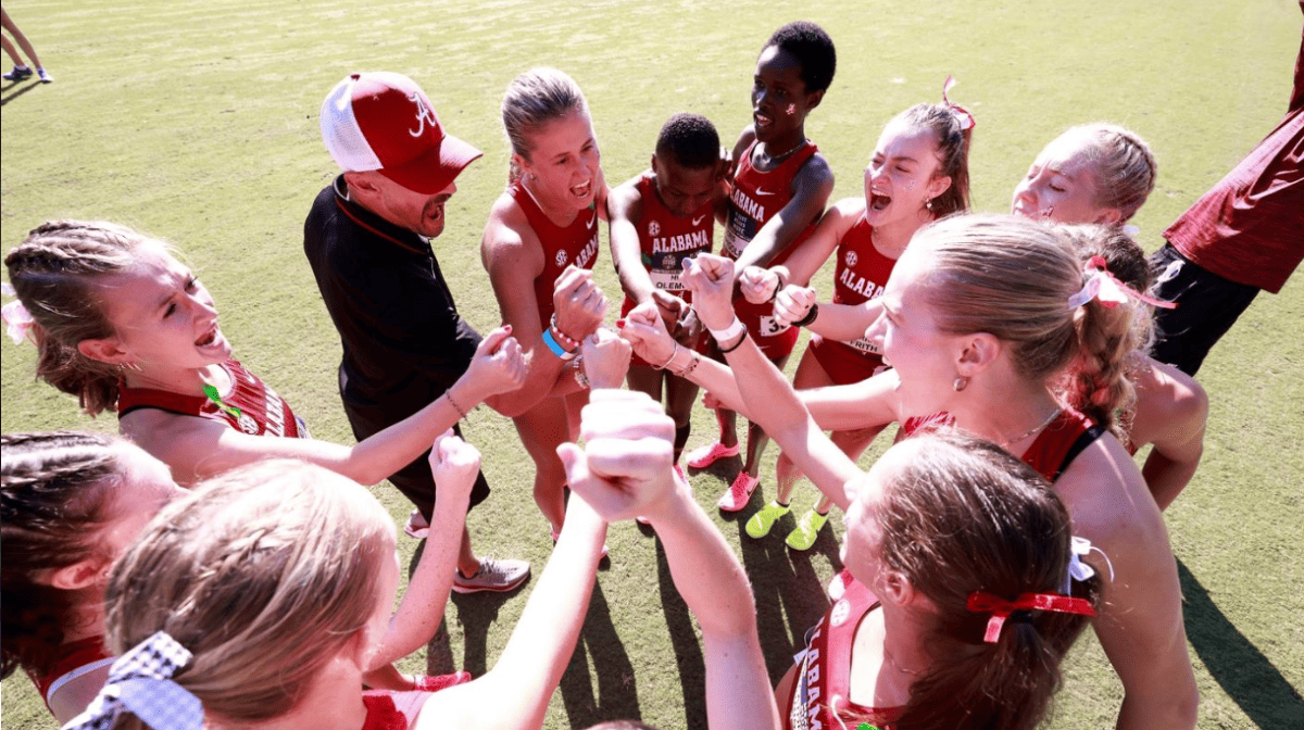 Members of the Alabama Cross Country team in a huddle before a meet.