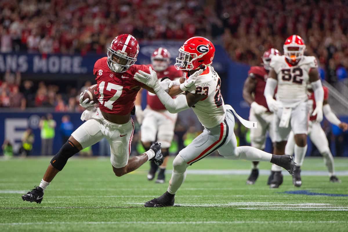 Alabama+wide+receiver+Isaiah+Bond+%28%2317%29+attempts+to+stiff+arm+a+Georgia+defender+during+the+SEC+Championship.