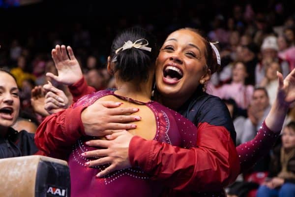 Alabama gymnast Shania Adams celebrates her beam routine against Arkansas with teammate Makarri Doggette on Jan. 19 in Coleman Coliseum.