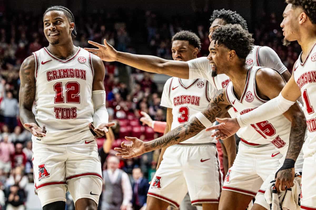 The Alabama bench celebrates after guard Latrell Wrightsell Jr. (#12) scores.