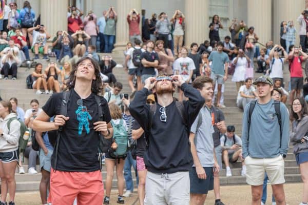 Students watch the eclipse in front of Gorgas Library.