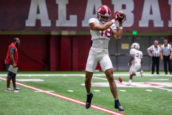 Alabama wide receiver Caleb Odom (#18) catches a ball during practice.