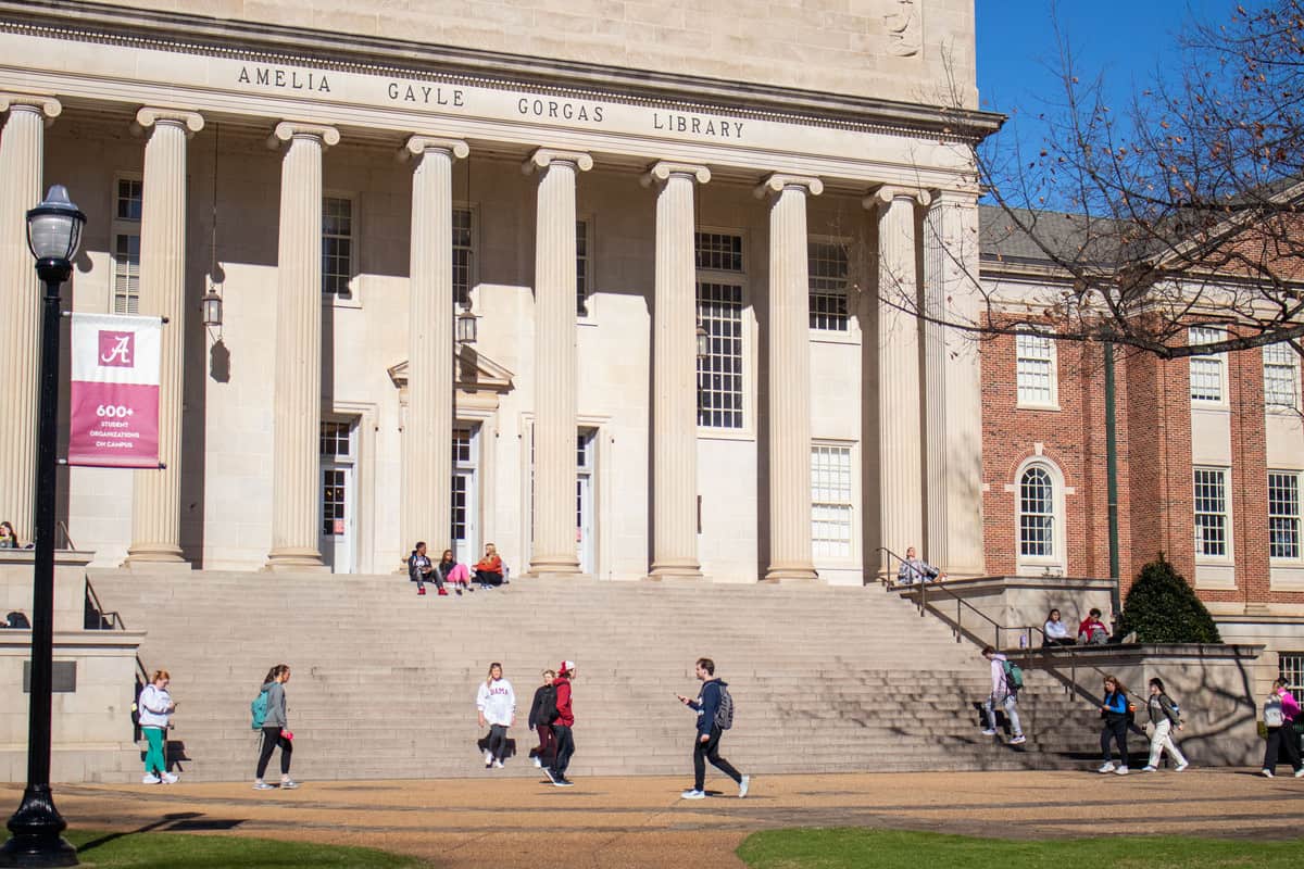 Students outside of Gorgas Library on a sunny afternoon.
