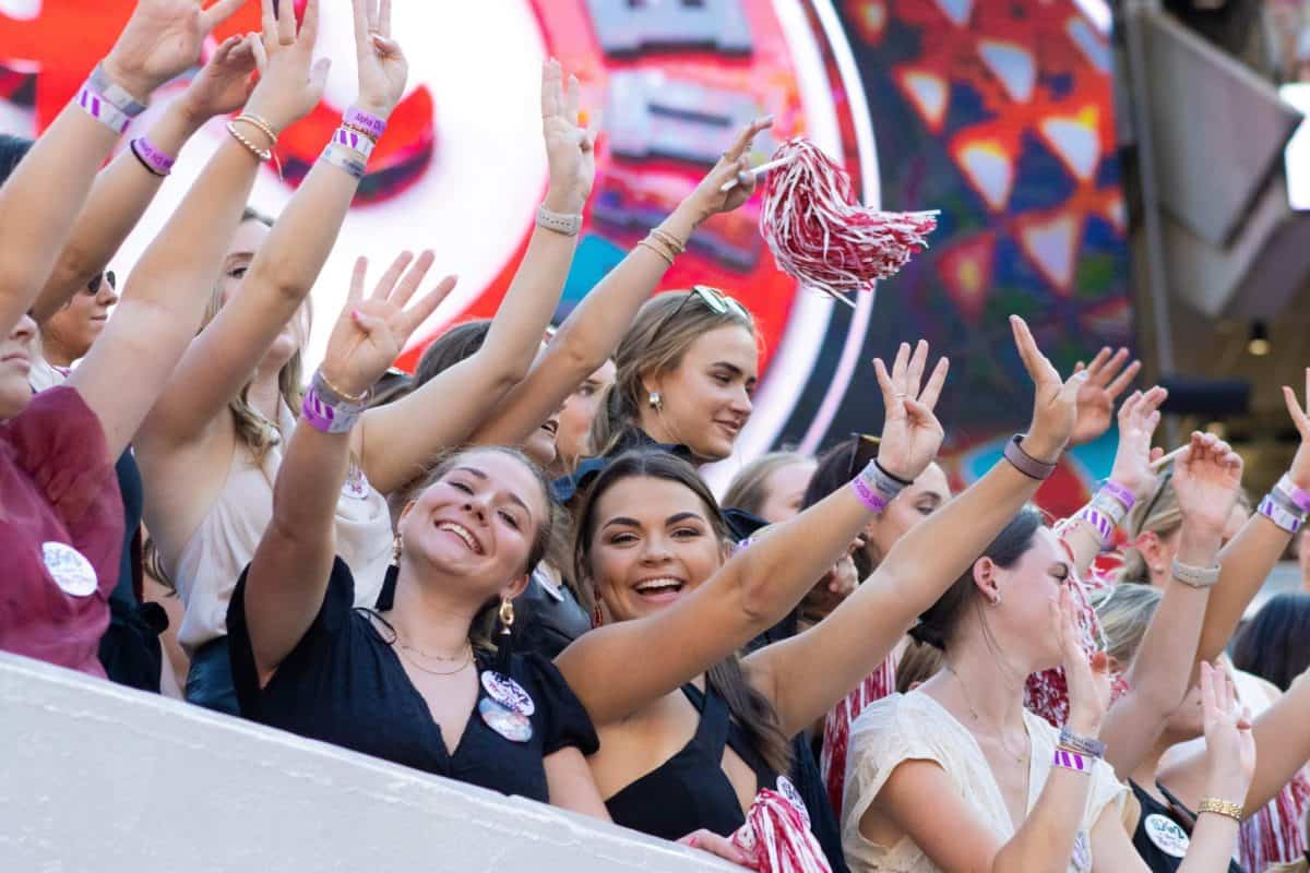 Students cheer in the student section at a home football game. 