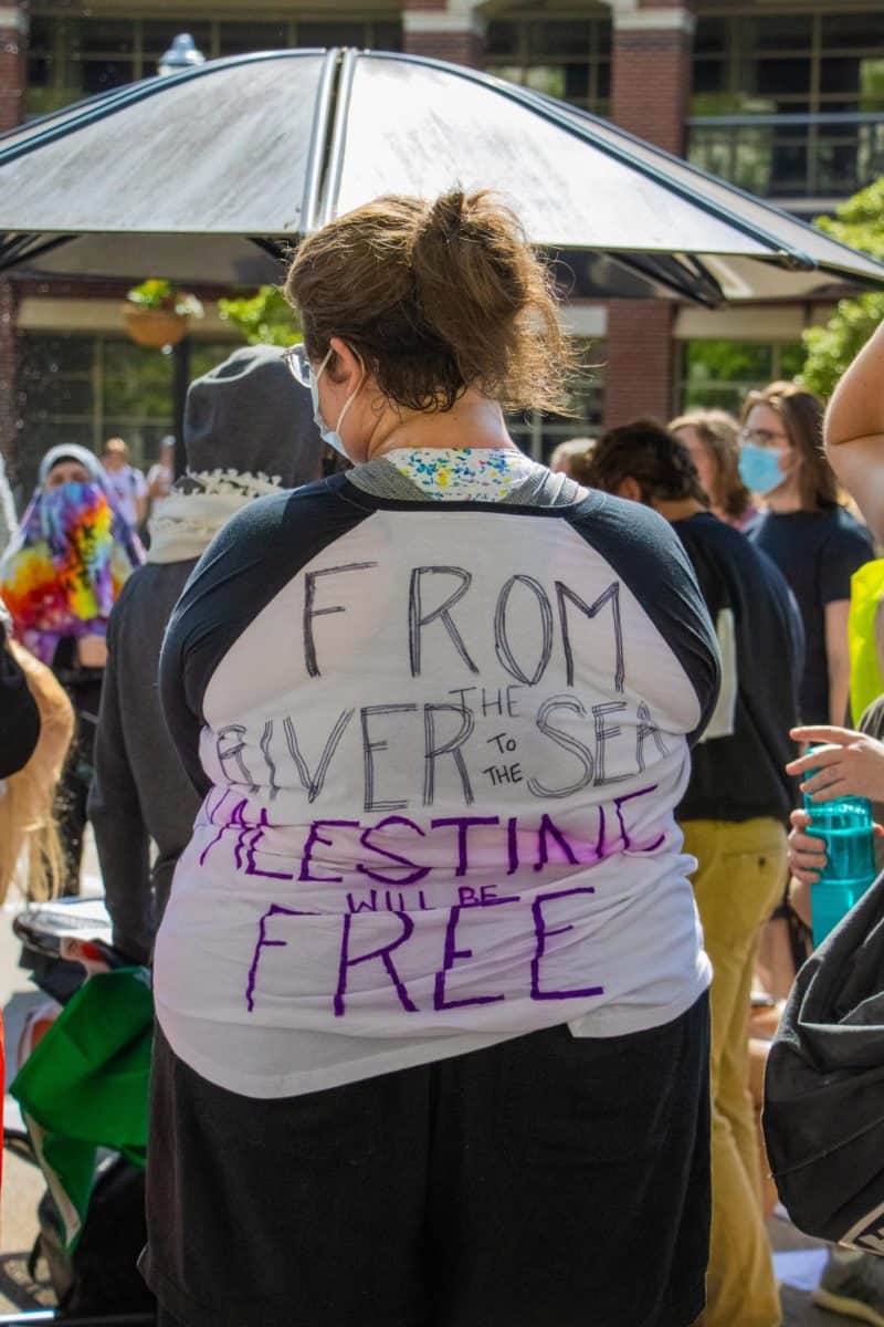 An anti-war protester wears a shirt in support of the ceasefire.
