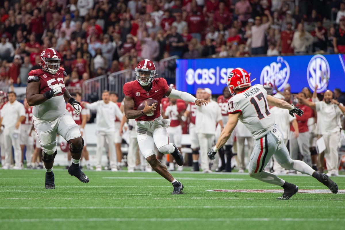 Jalen Milroe carries the football at the SEC Championship game.