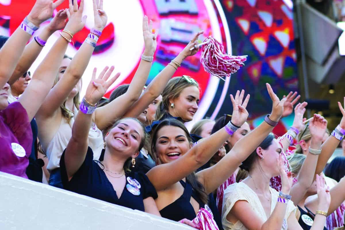 Students cheer in the student section at a home football game. (CW/ Caroline Simmons) 