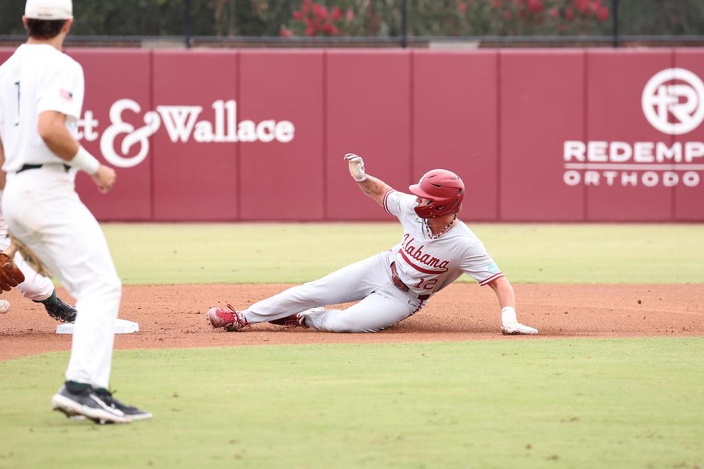 Alabama baseball player Gage Miller (12) slides into second against Stetson at Mike Martin Field at Dick Howser Stadium in Tallahassee, FL on Saturday, Jun 1, 2024.
