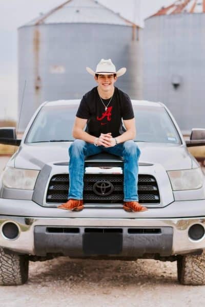 Caden Clay poses on a truck.