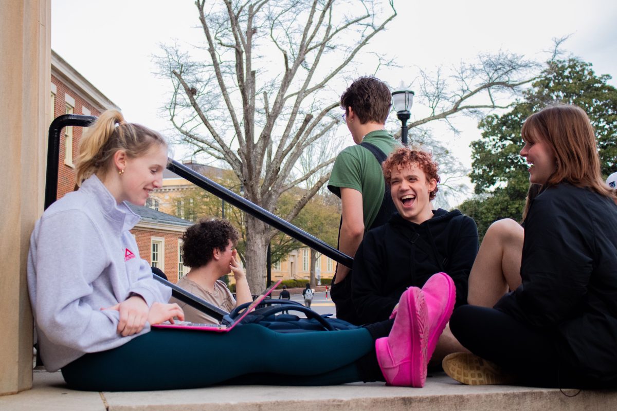 Students laughing together on the steps on Gorgas Library.