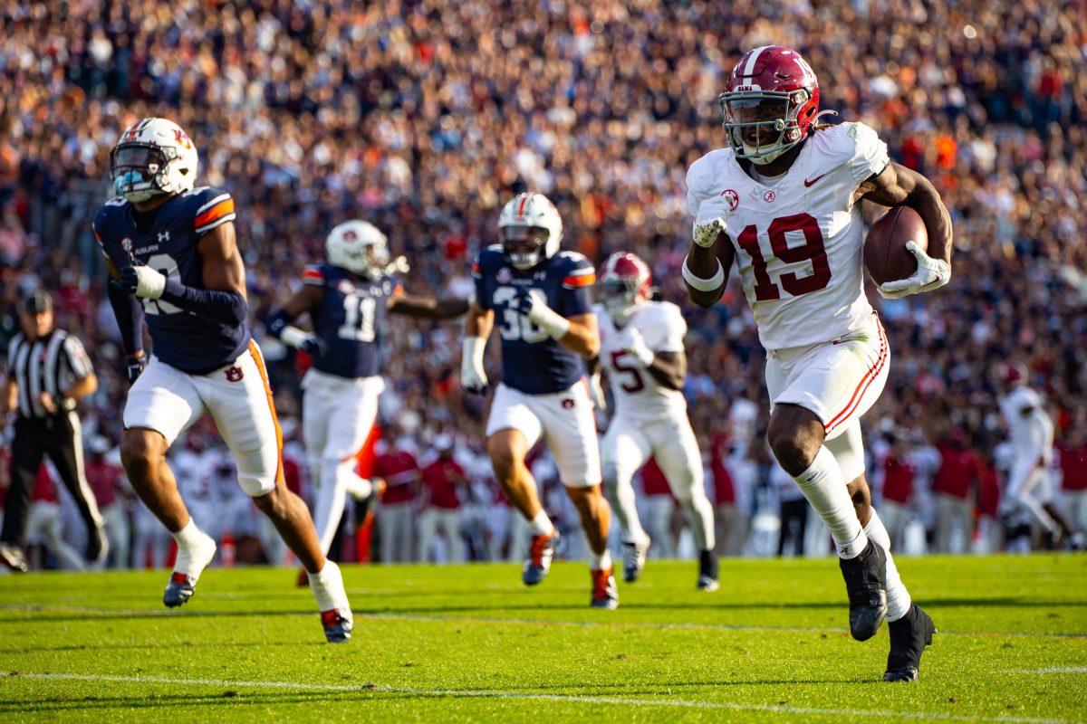 Alabama wide receiver Kendrick Law (#19) runs down the field against Auburn during the 2023 Iron Bowl.