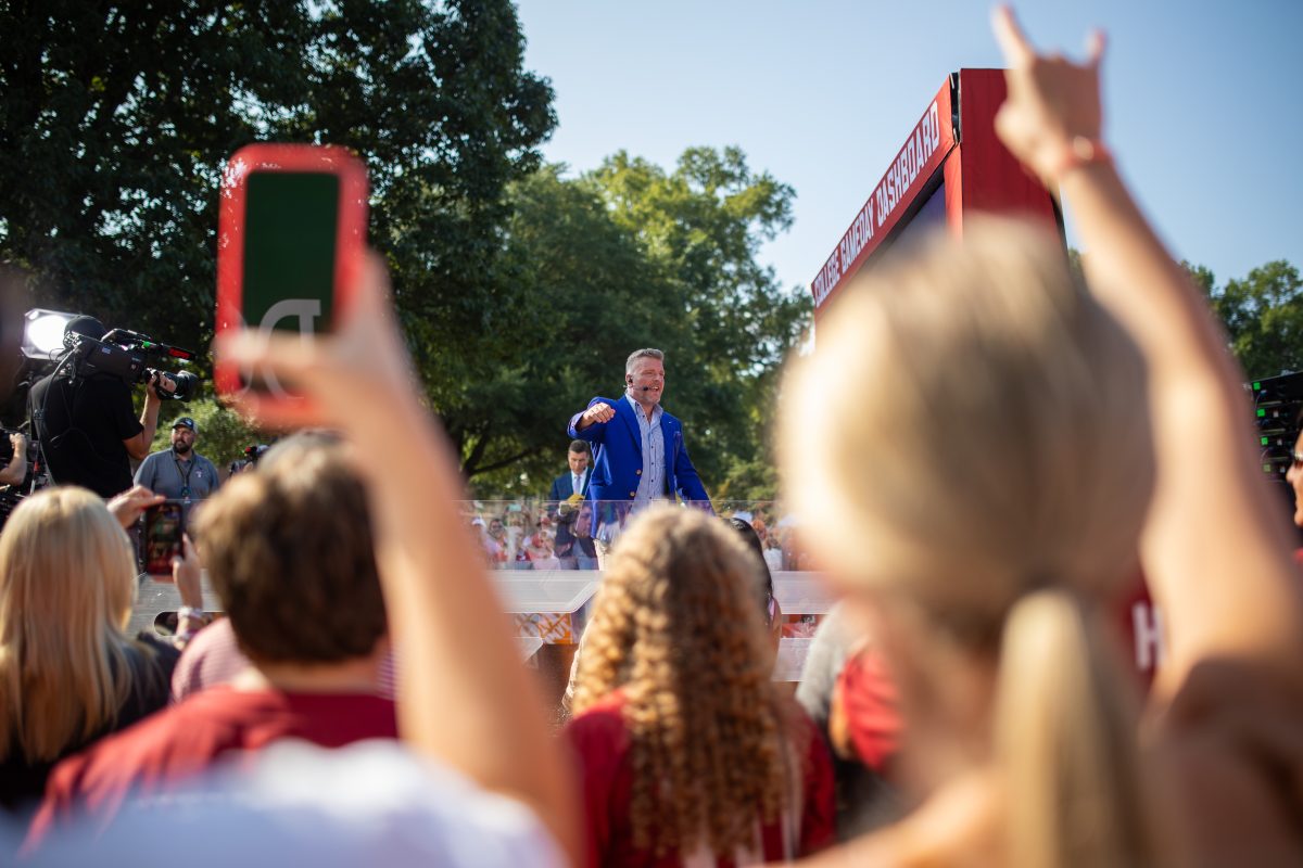 A student throws a horns up hand signal during College GameDay prior to Alabamas football game against Texas in 2023.