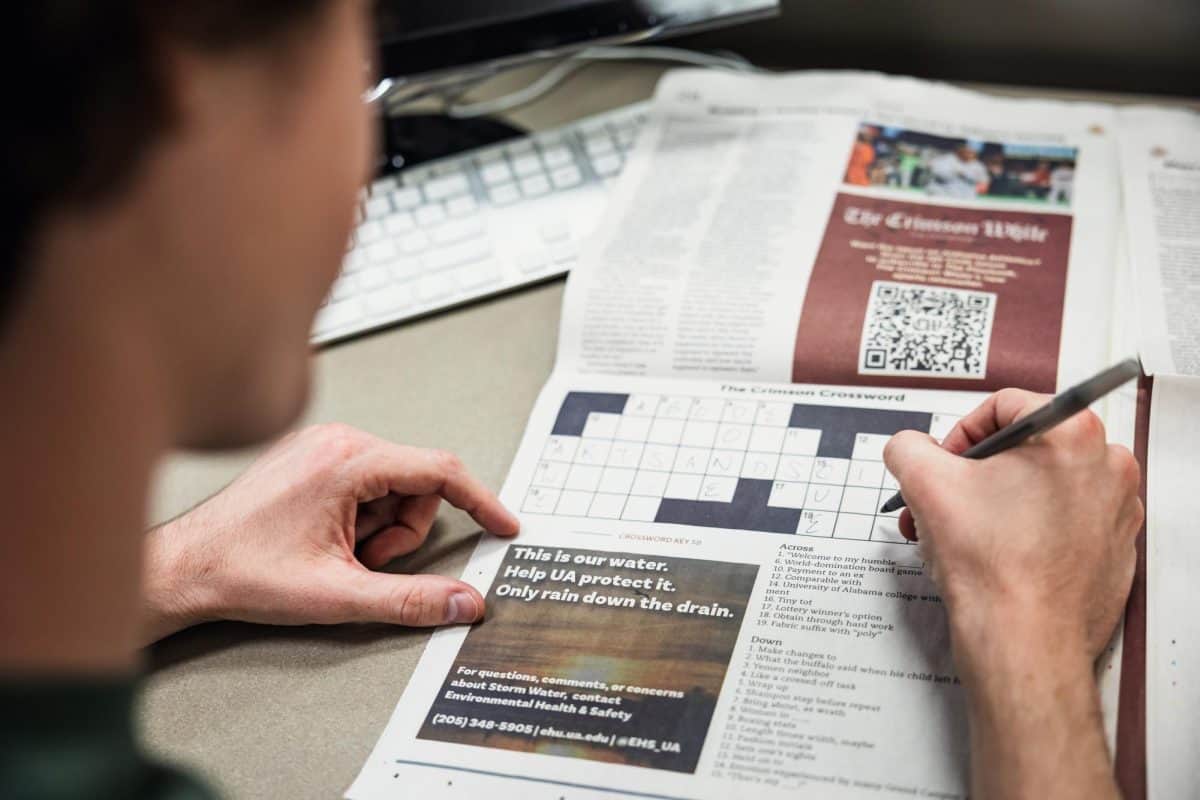 A student fills out a crossword puzzle.