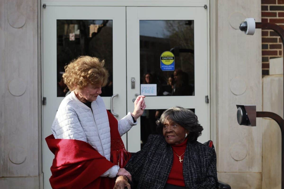 Two women being hospitable to one another.